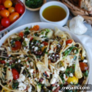 Sun-Kissed Mediterranean Pasta 8 Large white bowl filled with vibrant Mediterranean Pasta, topped with fresh feta and herbs, ready to serve.