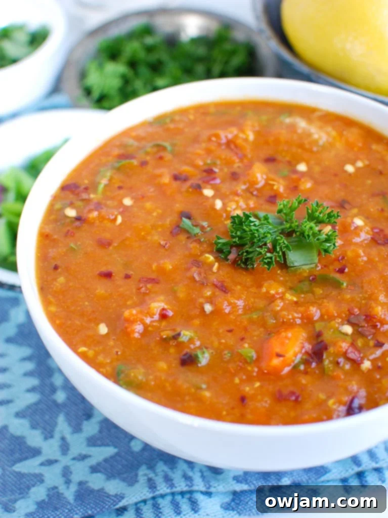 A comforting bowl of Slow Cooker Lentil Soup garnished with fresh herbs, perfect for a cozy meal.