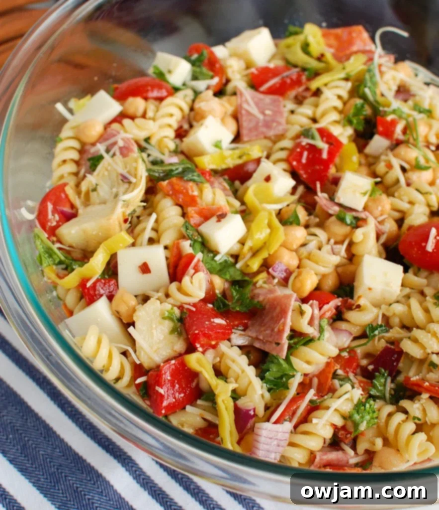 Close-up of Italian Pasta Salad in a clear glass bowl, showcasing the colorful ingredients