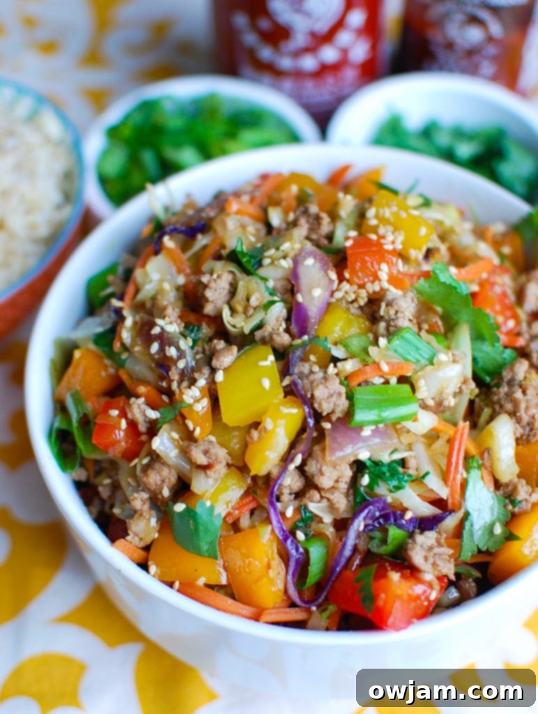 Egg Roll in a Bowl garnished with green onions and sesame seeds.