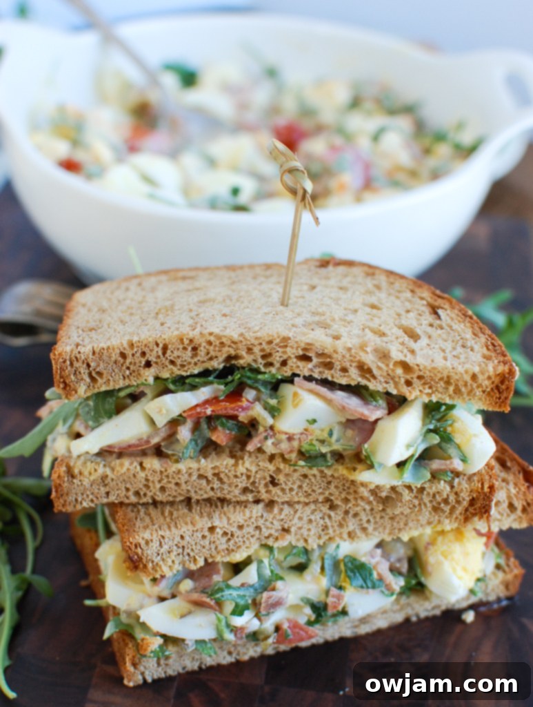 Close-up of a Bacon Egg Salad Sandwich on wheat bread.