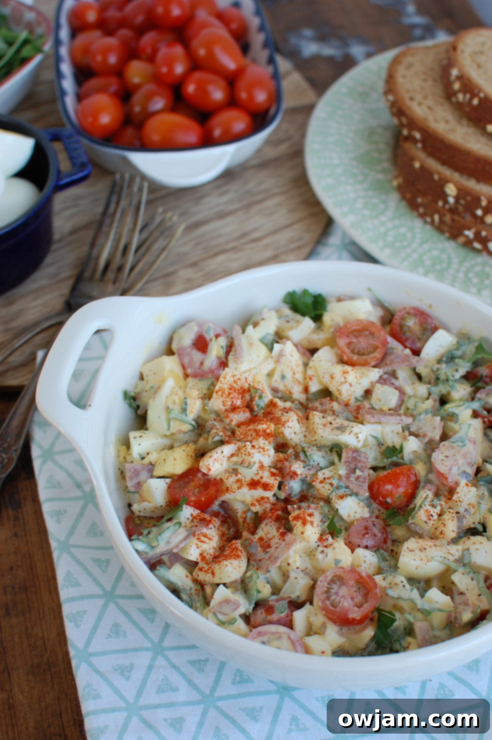 A serving of Bacon Egg Salad on a blue napkin, highlighting the fresh ingredients.