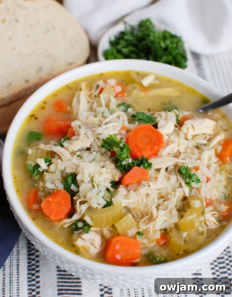 Comforting Crock Pot Chicken and Rice Soup 2 Slow Cooker Chicken and Rice Soup in White Bowl