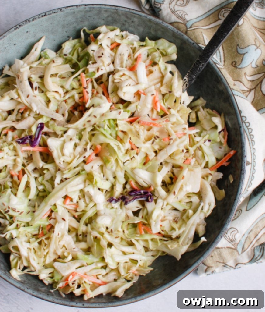 Creamy Coleslaw Recipe with blue bowl and spoon