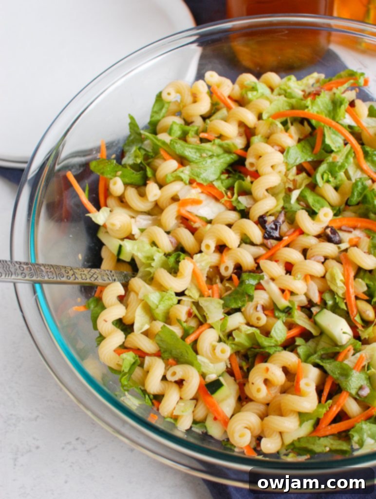Far East Fusion Pasta Salad 2 Vibrant Asian Pasta Salad served in a clear glass bowl, ready for a summer gathering.