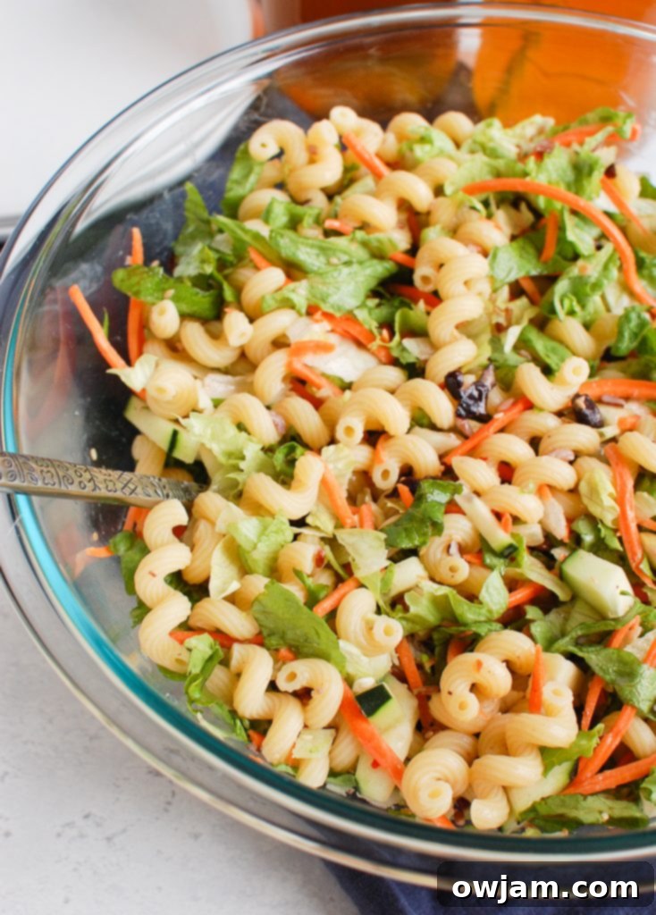 Far East Fusion Pasta Salad 5 Close-up of Asian Pasta Salad ingredients, showing carrots and other fresh components.
