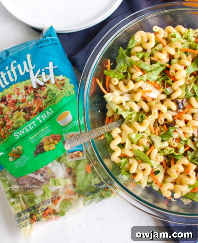 Far East Fusion Pasta Salad 6 The process of making Asian Pasta Salad, showing the Dole salad kit being added to cooked pasta in a bowl.