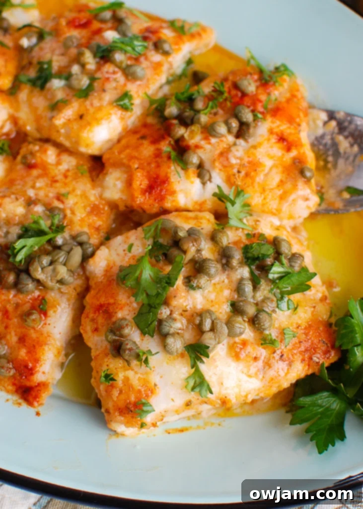 Lemon-Kissed Baked Cod 2 Baked Cod with Lemon on teal platter