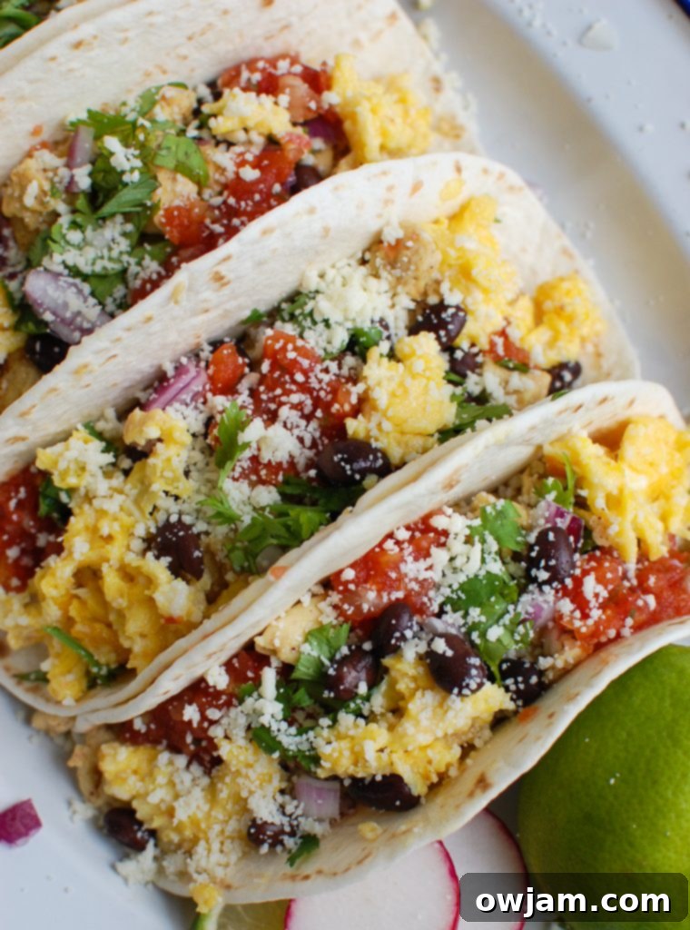 Southwestern Sunrise Tacos 2 Delicious Southwest Breakfast Egg Tacos beautifully arranged on a white platter, ready to be enjoyed.