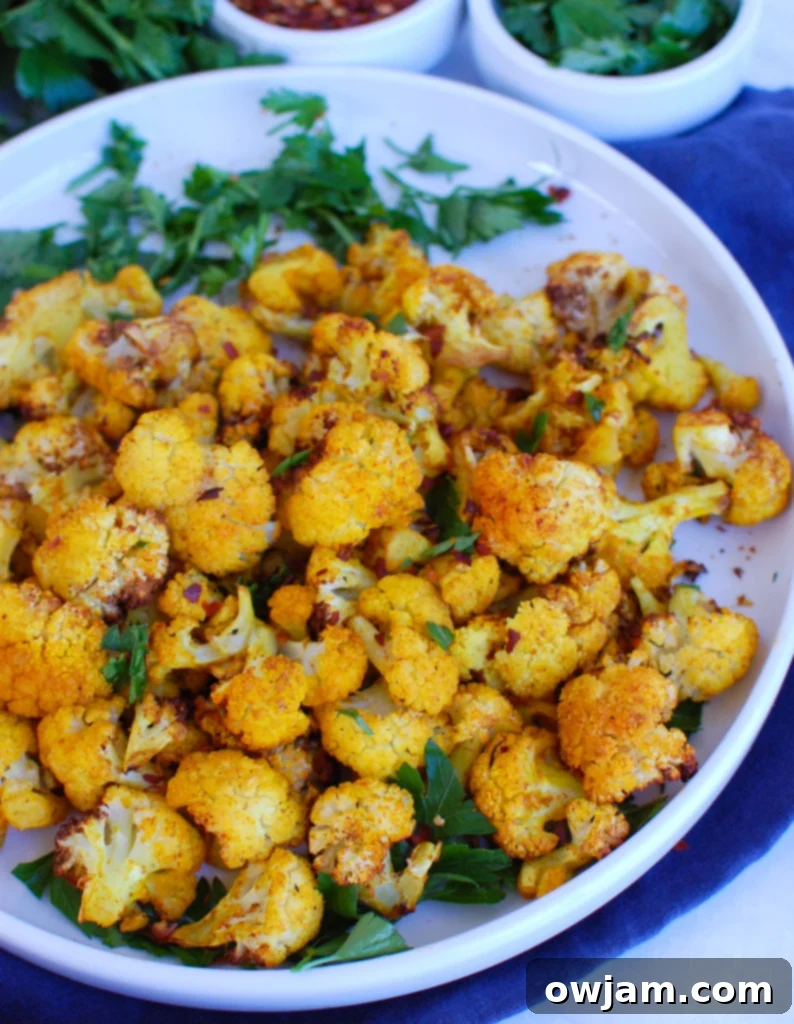 Crispy Air Fryer Cauliflower 3 Air Fryer Cauliflower served with a blue napkin, highlighting the delicious texture and perfect golden-brown crispness.