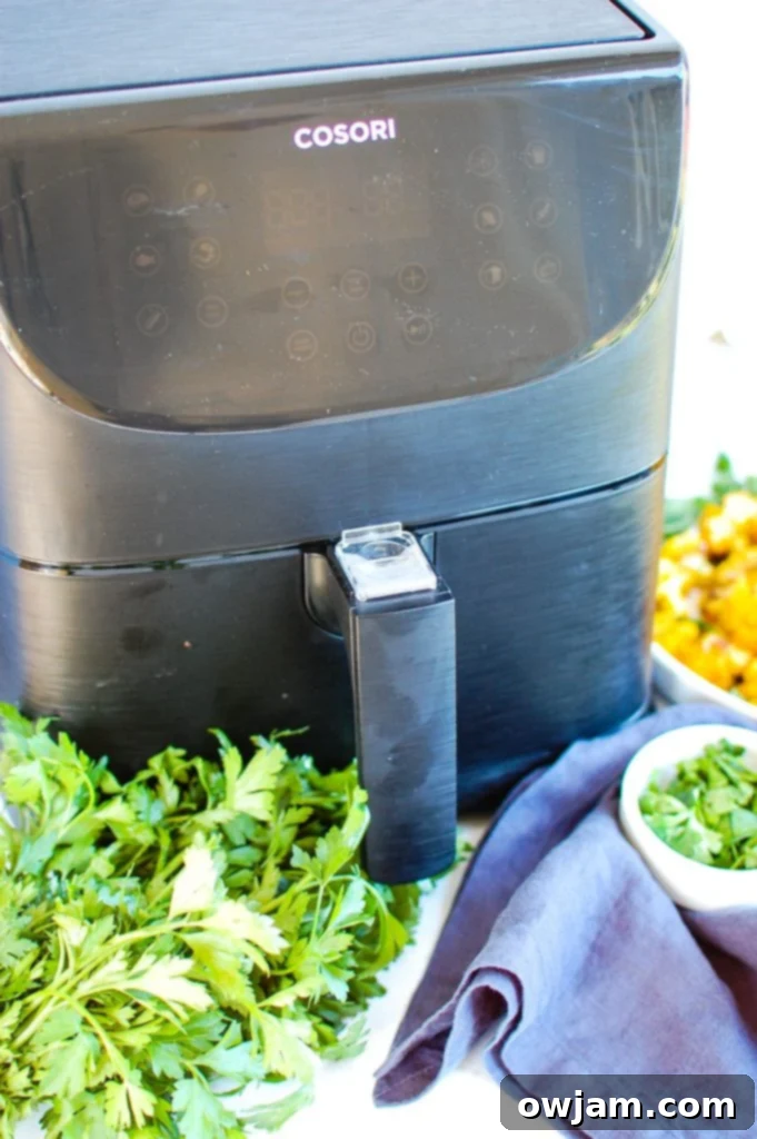 Crispy Air Fryer Cauliflower 4 Air Fryer Cauliflower cooking inside the air fryer basket, showing the process of healthy air frying.
