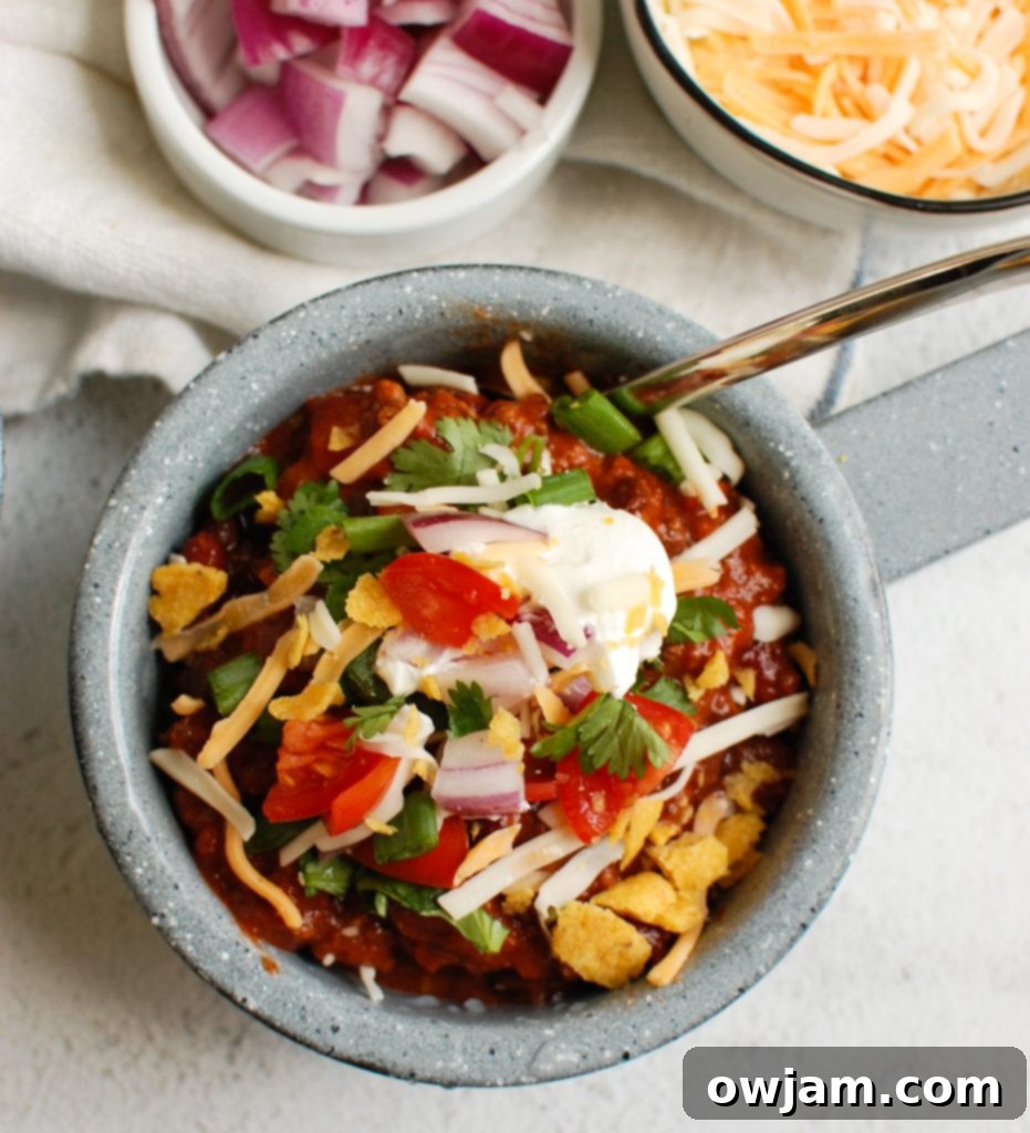 Rich & Robust Beef Chili 3 Beef Chili Recipe with a spoon in the bowl, showing texture