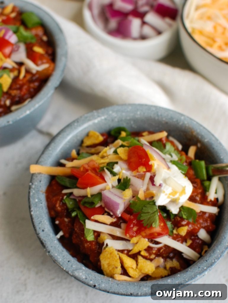 Rich & Robust Beef Chili 5 Beef Chili Recipe garnished with shredded cheese