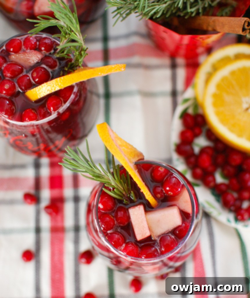 Merry Bright Sangria 5 Christmas Sangria with fresh cranberries, rosemary, and orange slices