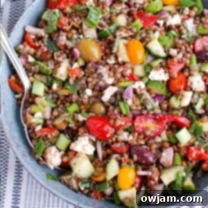 Vibrant Mediterranean Lentil Salad 6 Mediterranean Lentil Salad in a bowl with a spoon, showing its appealing texture and fresh ingredients.