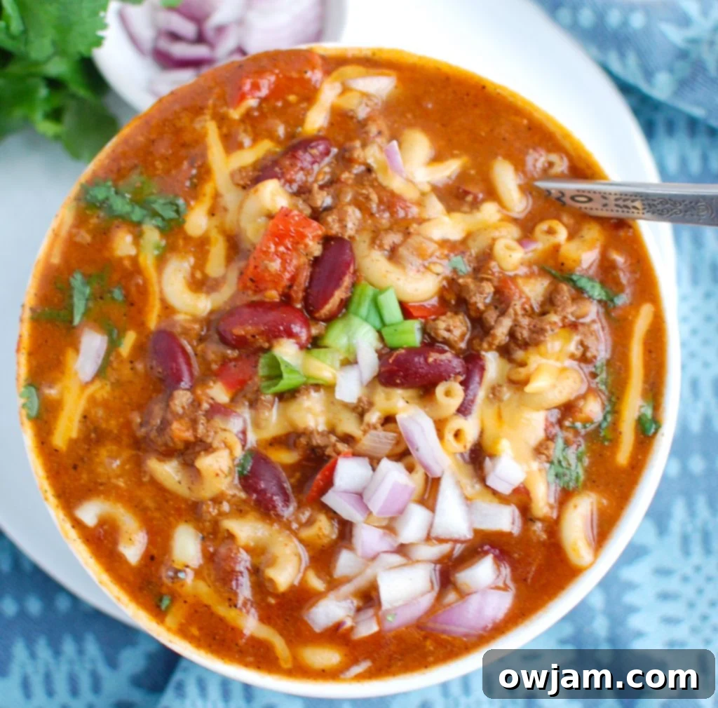 Instant Pot Chili Mac 3 Instant Pot Chili Mac topped with a sprinkle of chopped red onions, highlighting the rich chili and pasta mixture.