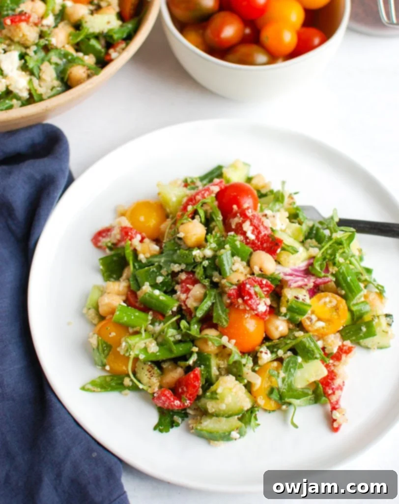 Mediterranean Quinoa Power Bowl 4 Mediterranean Quinoa Salad in a bowl with a fork, ready to eat
