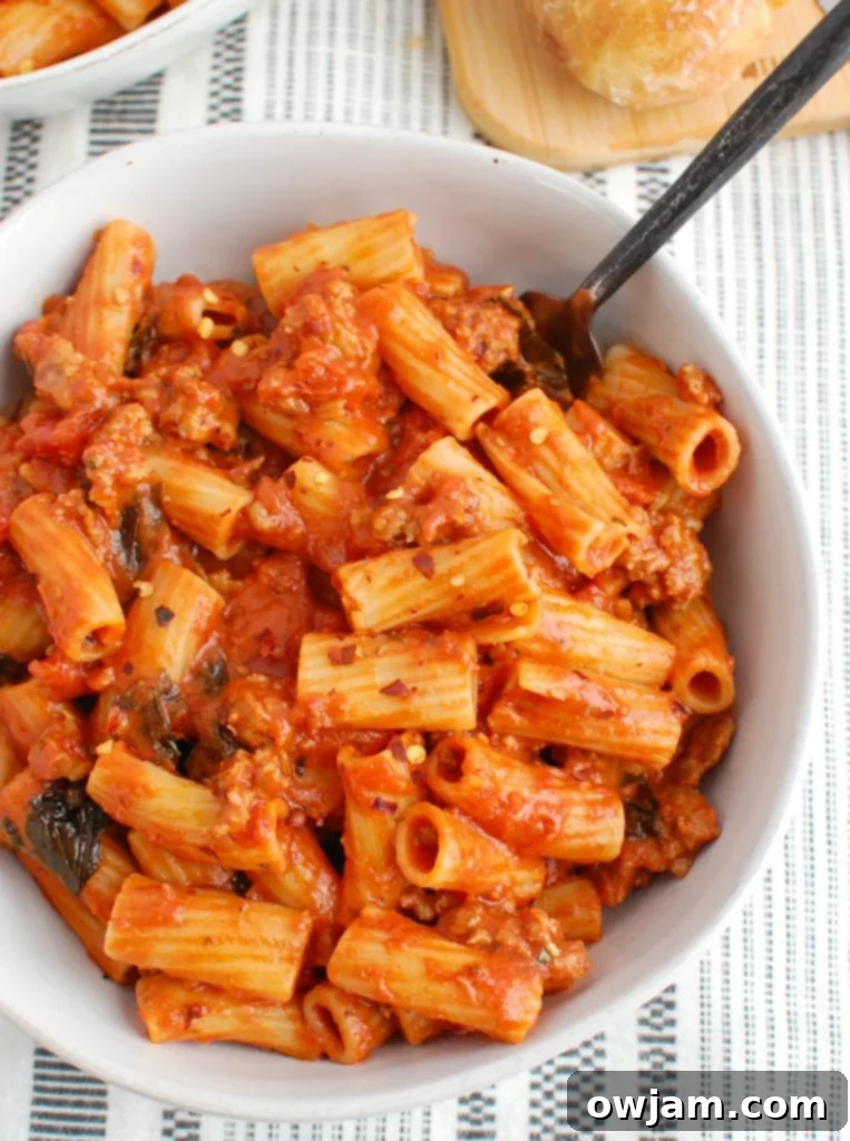 Zesty Sausage Pasta Supper 2 Creamy Italian Sausage Pasta in a white bowl, garnished with fresh basil