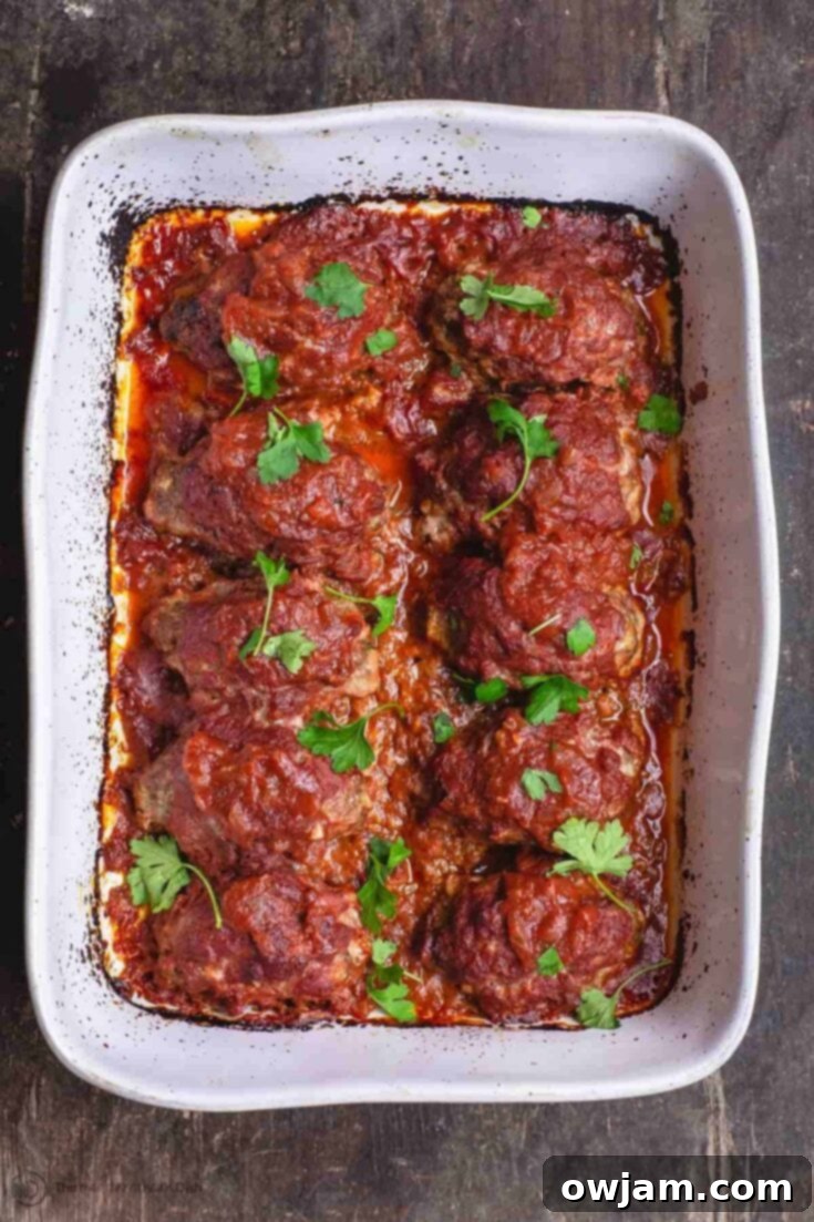 Traditional Greek Baked Meatballs (Soutzoukakia) in a rich tomato sauce