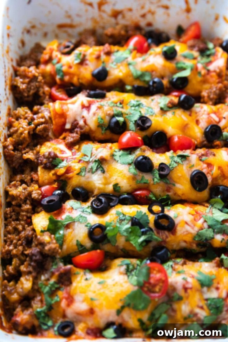 Easy Ground Beef Enchiladas baked in a savory sauce with cheese