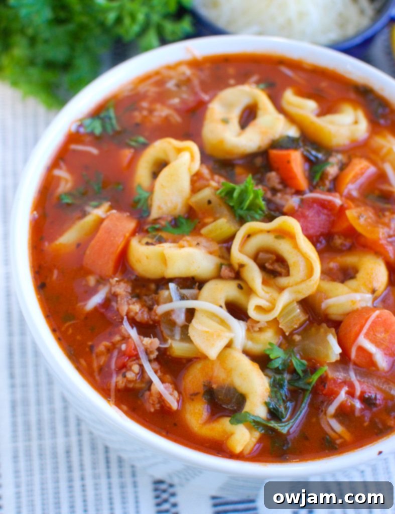 Tortellini Sausage Soup in white bowl