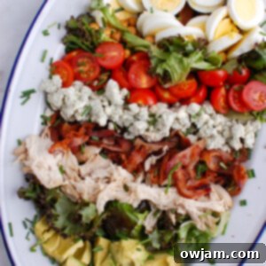 The Ultimate Cobb Salad 7 Cobb Salad with distinct layers on a plate, ready to be served