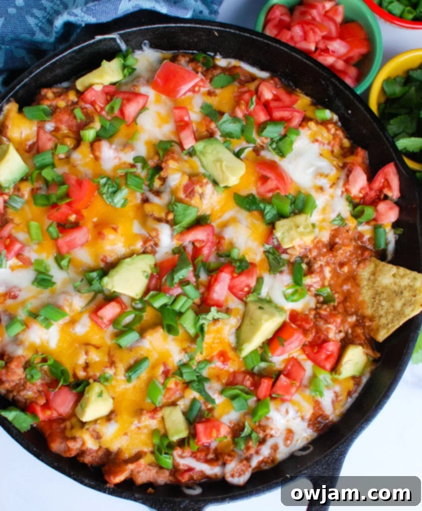 Loaded Beef Taco Dip 2 Beef Taco Dip in a skillet, garnished and ready to serve