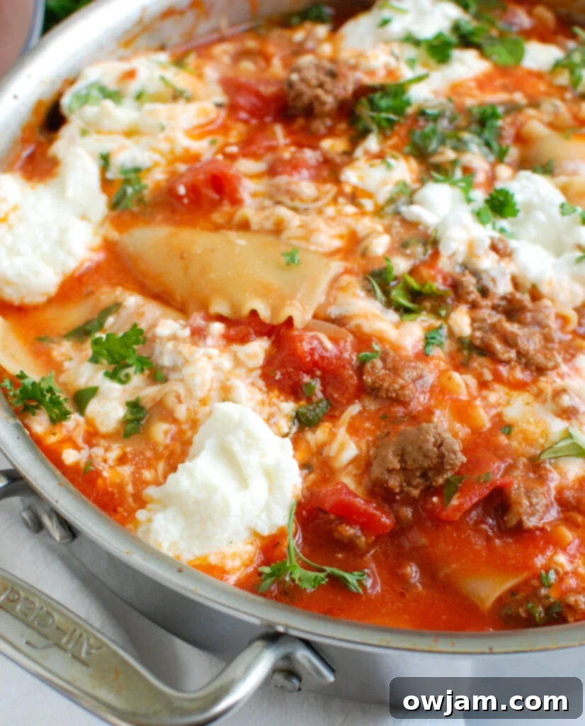 Hearty Skillet Beef Lasagna 5 Skillet Beef Lasagna cooking in a pan, topped with melting cheese, representing an easy and comforting Italian meal.