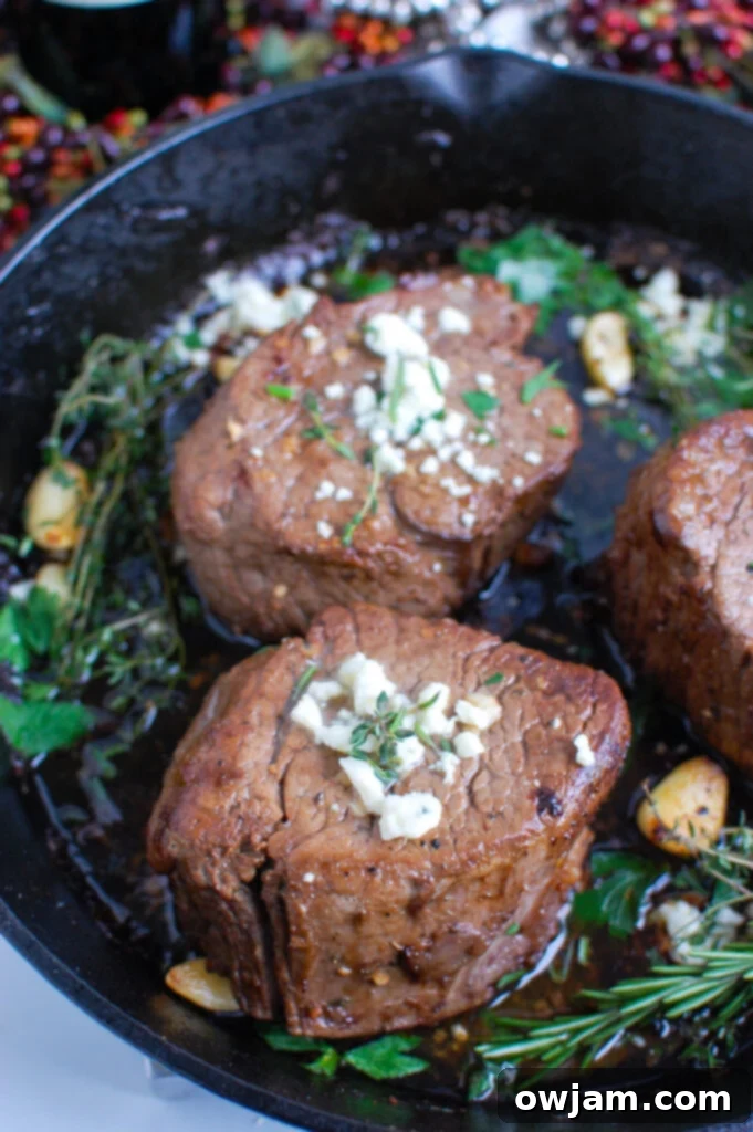 Decadent Tenderloin with Tangy Blue Cheese 5 Beef Tenderloin Steaks with Creamy Blue Cheese Sauce searing in a hot skillet, creating a beautiful crust.
