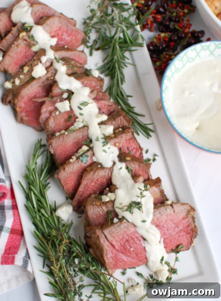 Decadent Tenderloin with Tangy Blue Cheese 6 Plated Beef Tenderloin Steaks with Creamy Blue Cheese Sauce, garnished and ready to serve.