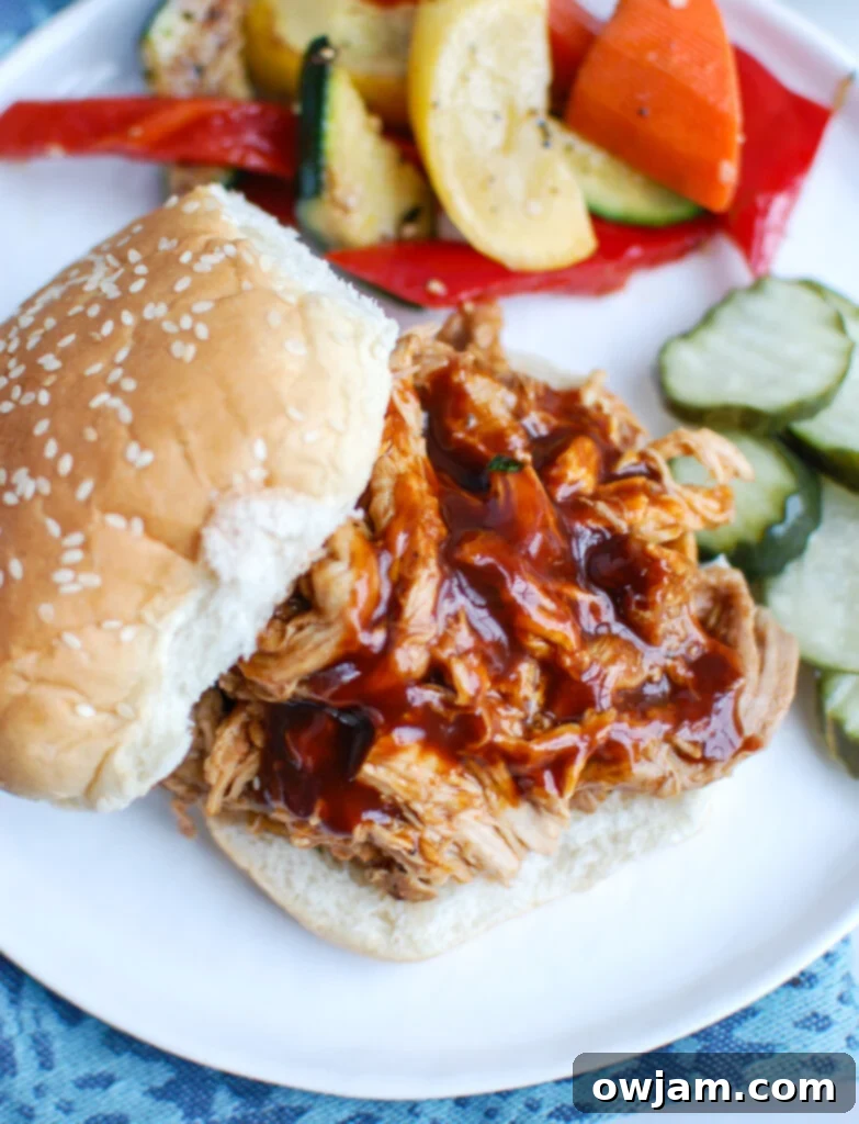 Slow Cooker Pork Roast with bun, ready for a pulled pork sandwich