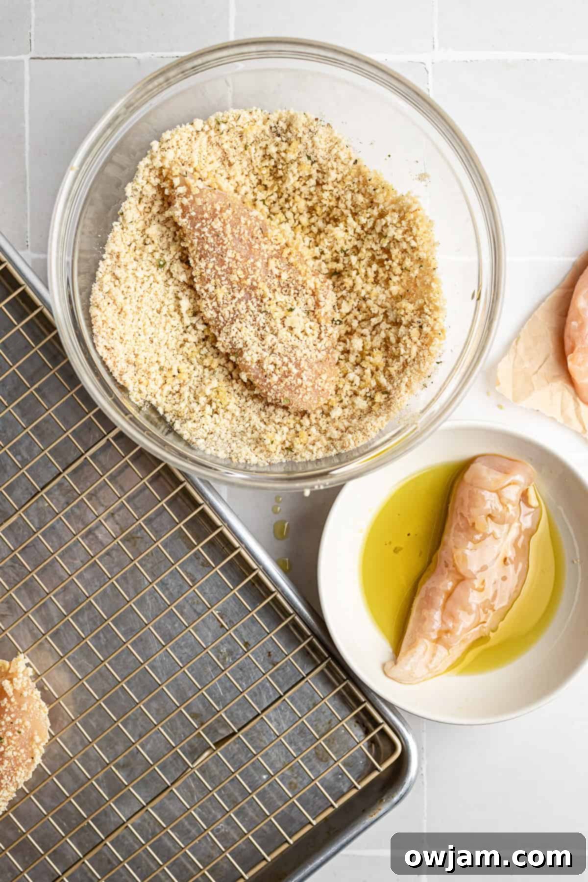 Super Crispy Easy Baked Chicken Tenders 5 Dredging raw chicken tenders in olive oil before coating them in the panko breadcrumb mixture.