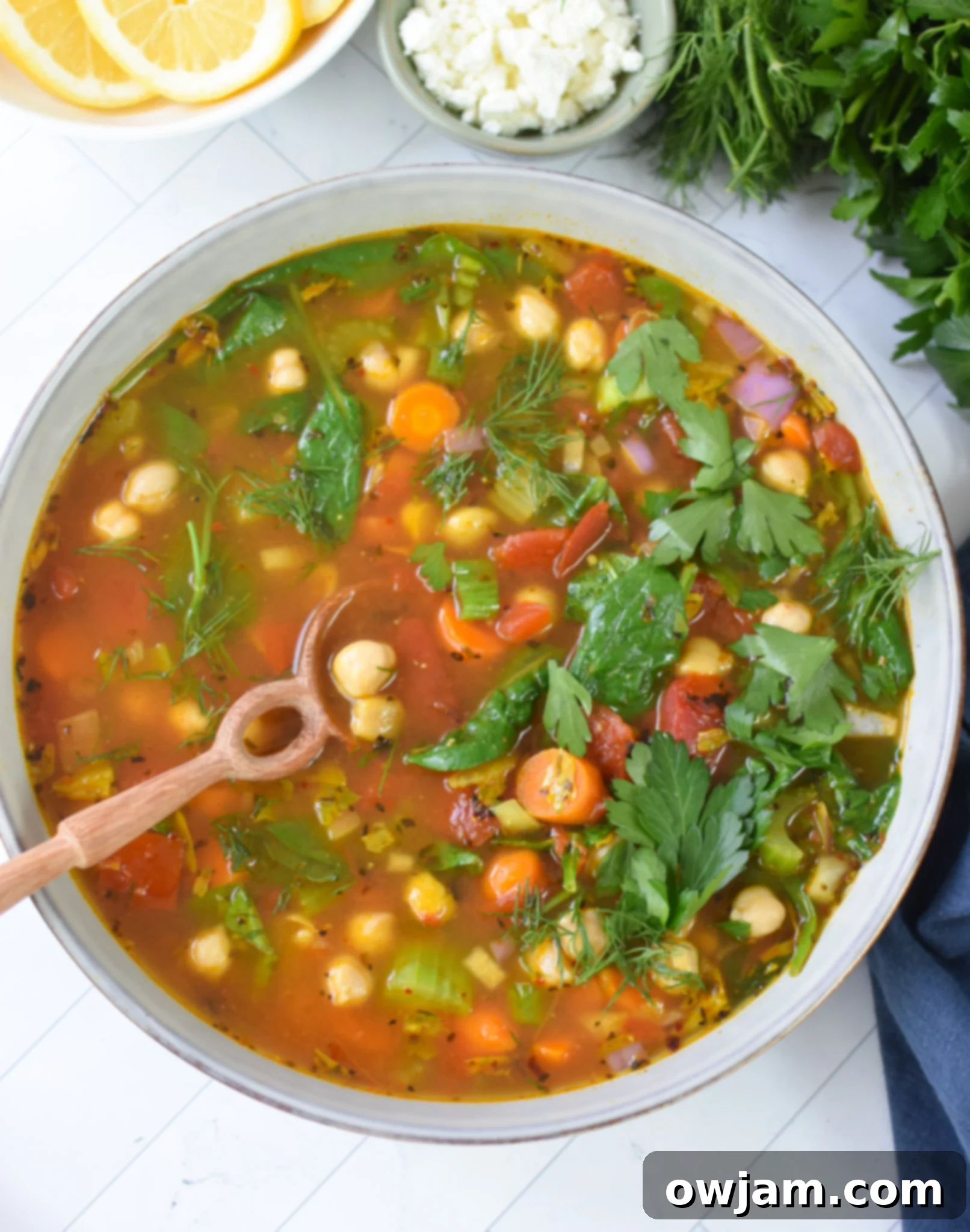 Garbanzo Soup Recipe in a blue bowl with a spoon.