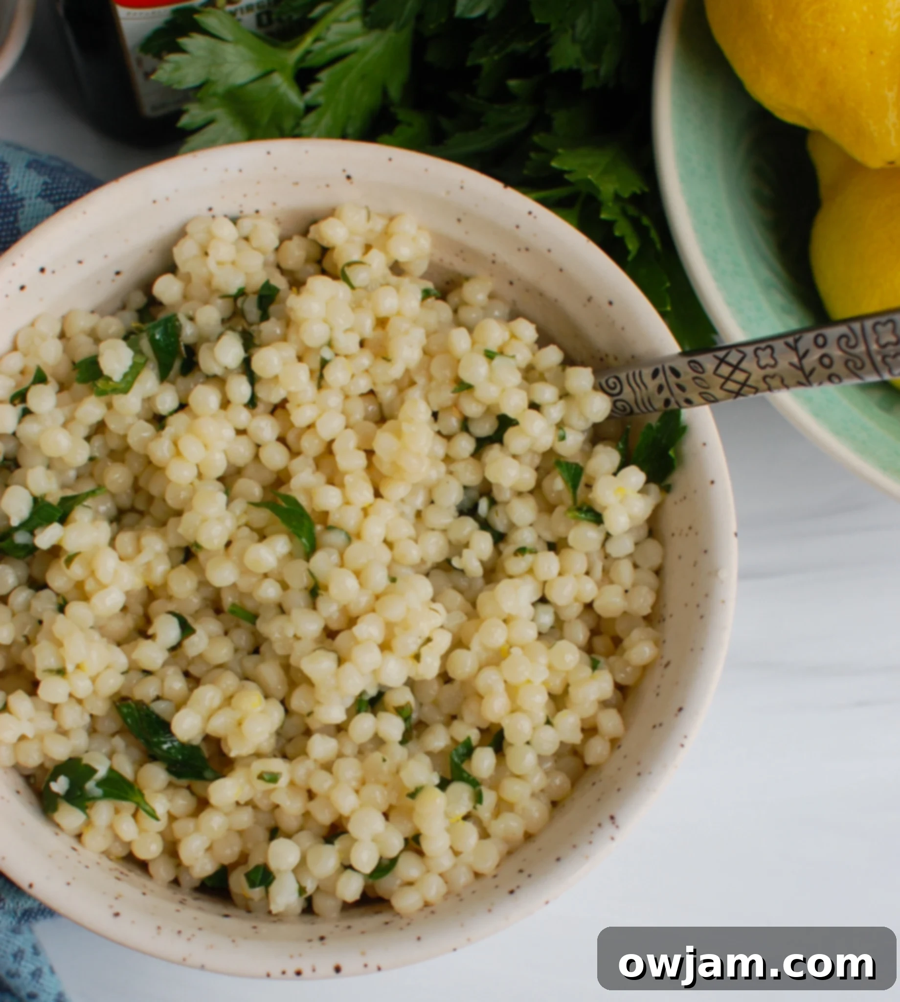 Zesty Lemon Pearl Couscous Delights 4 Lemon Pearl Couscous Recipe with spoon.