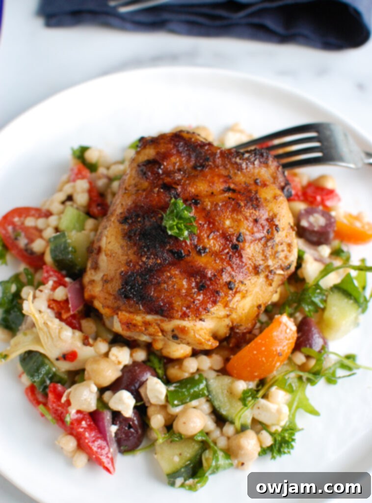Grilled Chicken Thighs with Greek Marinade on white plate with lemon