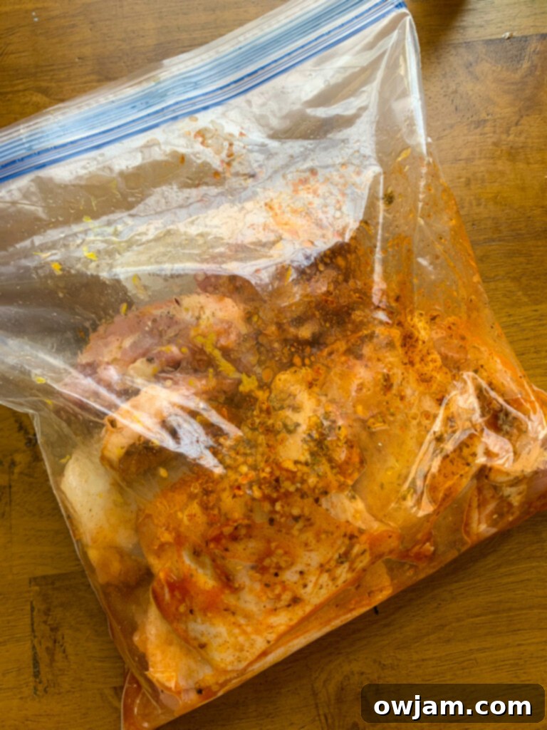 Grilled Chicken Thighs with Greek Marinade marinating in a ziplock bag