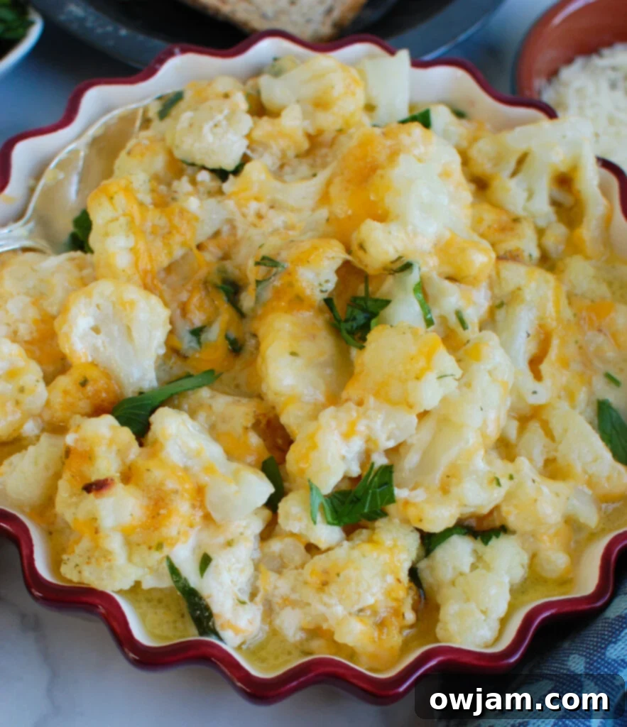 Cauliflower Cheese 2 Cheesy Cauliflower in red dish, golden and bubbling