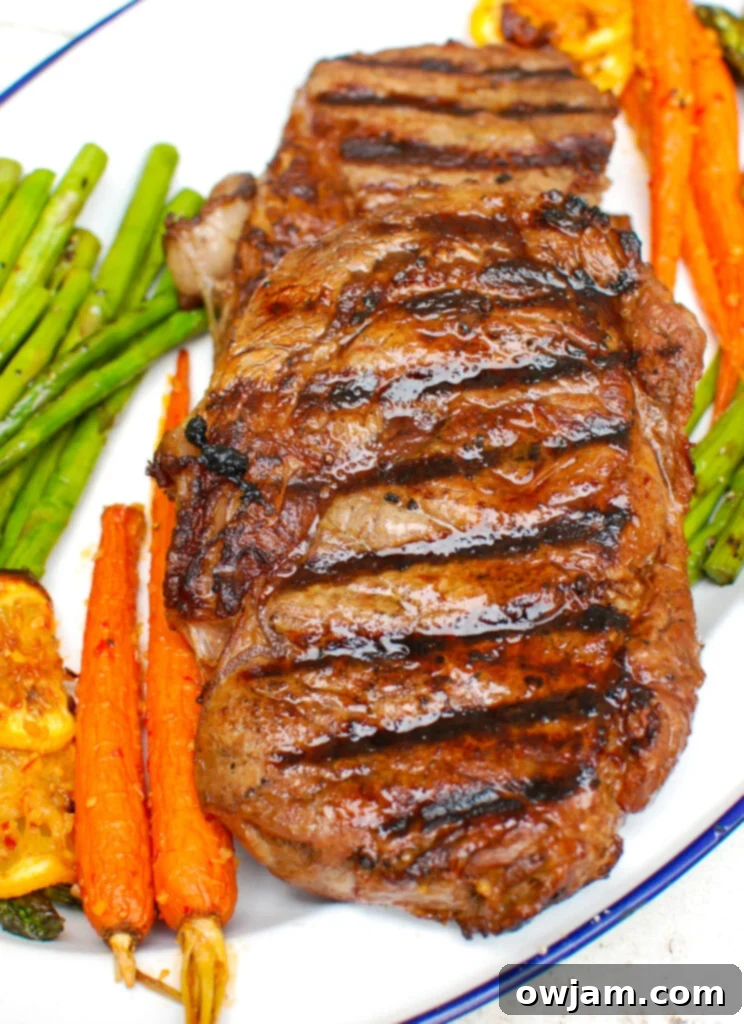 Lemon Garlic Butter Grilled Ribeye on cutting board 
