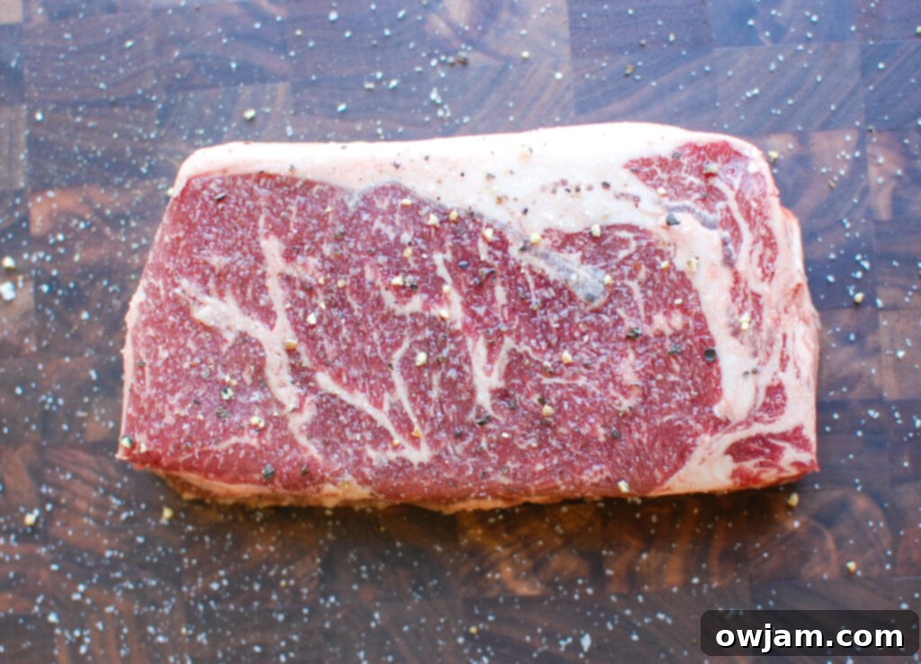 Lemon Garlic Butter Grilled Ribeye on cutting board with salt