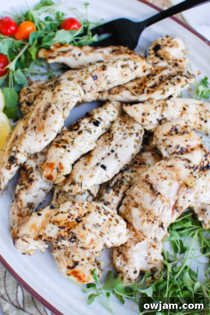Lemon Marinade for Chicken on a white platter with fresh herbs