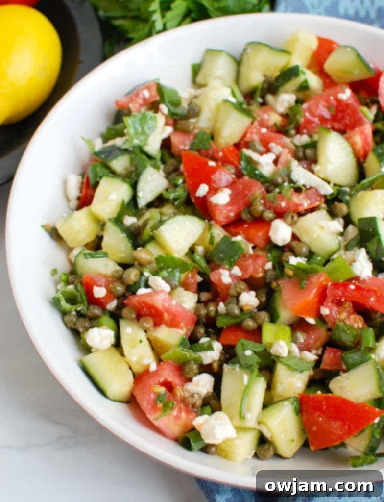 Vibrant Tomato Cucumber Caper Salad 2 Vibrant Tomato and Cucumber Salad with Capers in a white bowl, ready to be served.