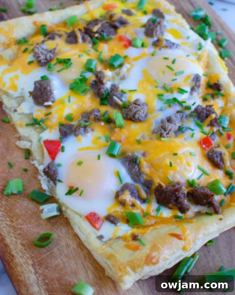 Turkey Sausage and Egg Puff Pastry Pizza on cutting board, ready to be served