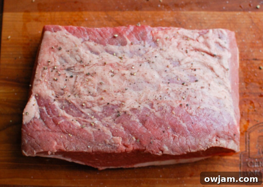 Slow Cooker Beef Brisket served in a rustic bowl, garnished with fresh cilantro and lime
