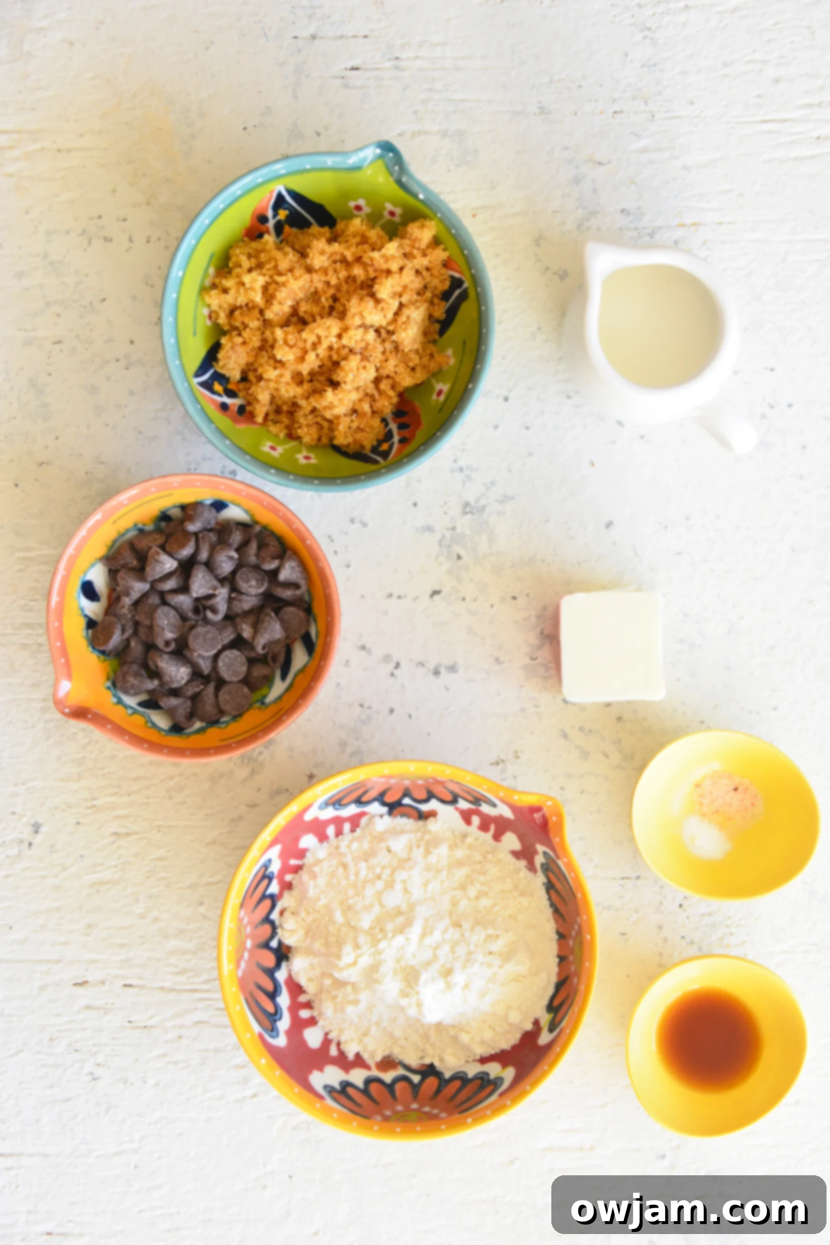 Essential ingredients laid out for making edible cookie dough for one, including butter, sugar, flour, milk, and chocolate chips.