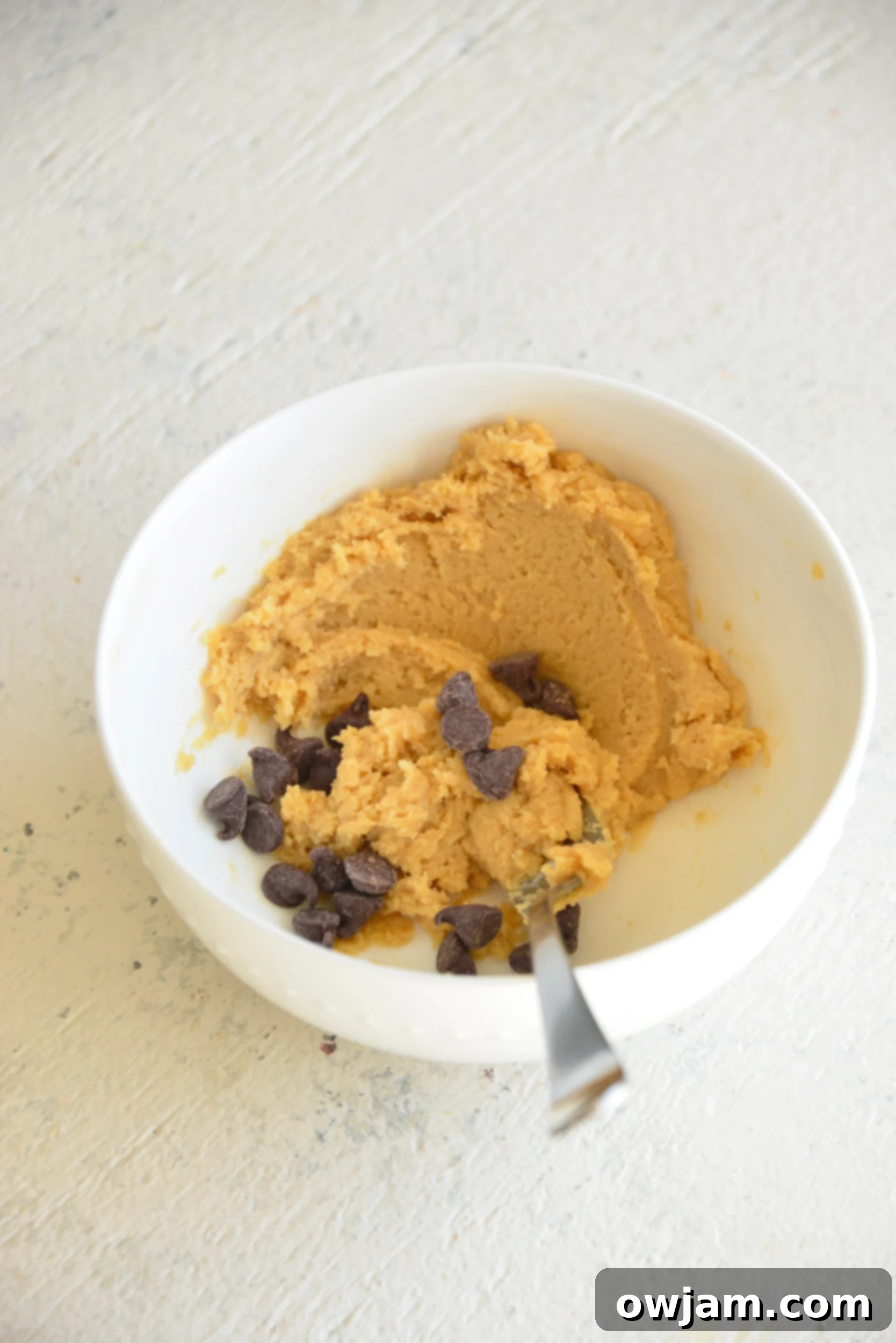 The initial crumbly dough mixture for edible cookie dough for one before adding milk and chocolate chips.
