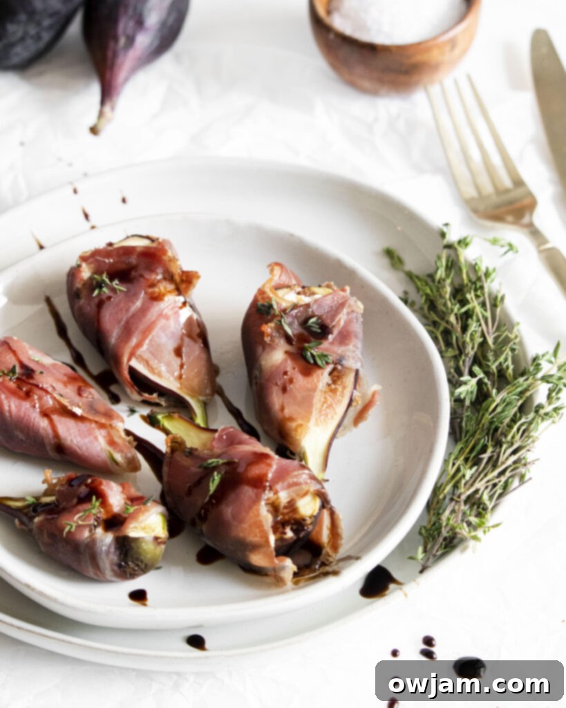 Prosciutto Wrapped Fig Goat Cheese Delights 7 Goat Cheese Figs Wrapped in Prosciutto with a fork, ready to be eaten