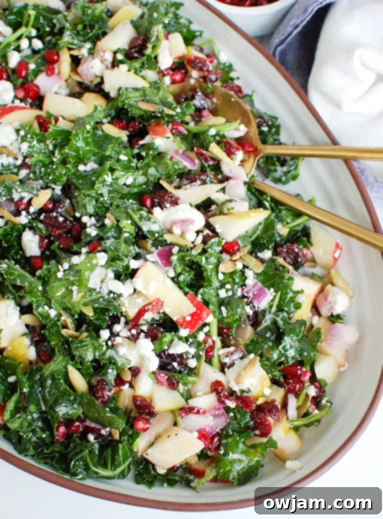 Easy Fall Salad in white dish, garnished with cranberries and pumpkin seeds