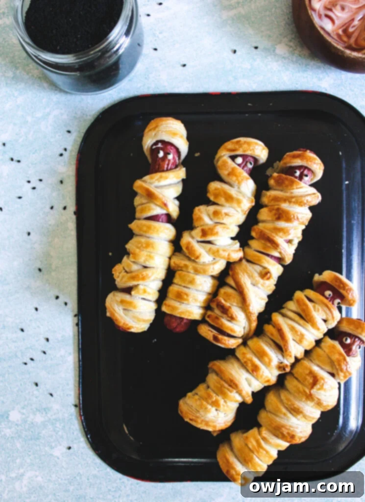 Mummy Hot Dogs on black plate