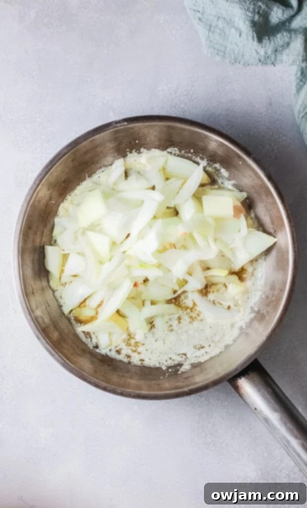 Golden Skillet French Onion Gnocchi 5 Thinly sliced onions caramelizing in butter in a pan