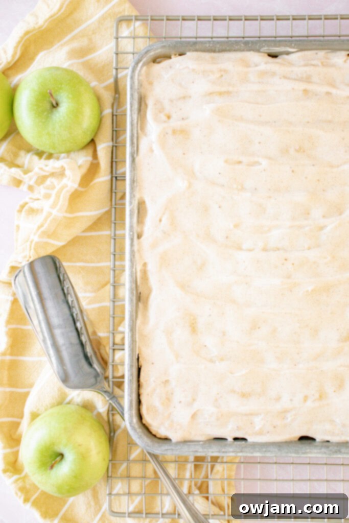 Pumpkin Spice Iced Apple Bars 8 Finished Apple Bars with Pumpkin Pie Spice Icing, garnished with a sliced apple for presentation.